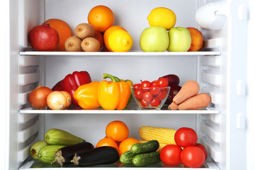 Fototapeta na wymiar Open fridge full of vegetables and fruits