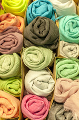 Obraz na płótnie Canvas series of colored cotton scarves rolled up