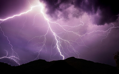 Powerful purple lightning during a thunderstorm
