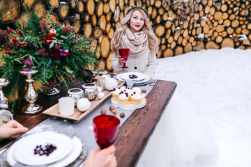 Cheerful bride is tenderly looks at her groom. Selective focus on the girl. Winter wedding