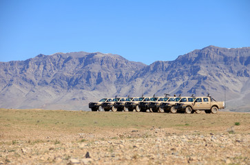 Landscape with military vehicles and mountains