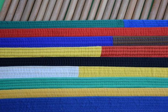 Karate belts on bamboo cane background