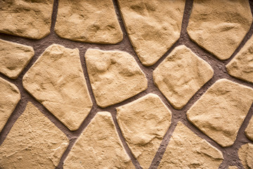 a wall decorated with brown stones