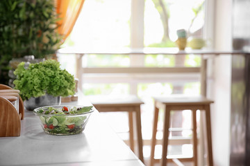 Bowl with tasty vegetable salad in modern kitchen