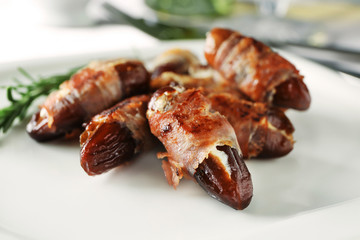 Plate with bacon wrapped dates, closeup