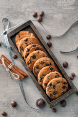 Wooden tray with delicious oatmeal cookies on table