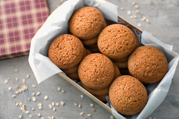 Box with delicious oatmeal cookies on table