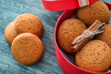 Box with delicious oatmeal cookies on wooden table