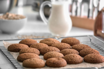 Cooling rack with delicious oatmeal cookies on kitchen table
