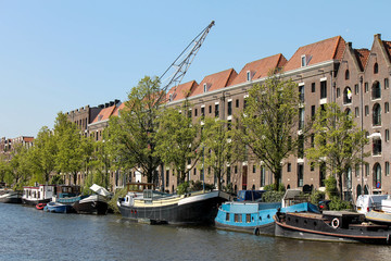 Old warehouses and ships along an Amsterdam canal
