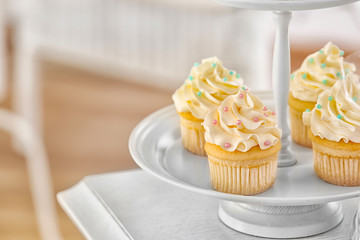 Dessert stand with tasty cupcakes, closeup