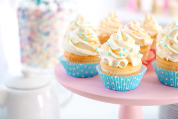 Stand with delicious cupcakes, closeup