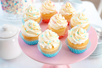 Stand with delicious cupcakes, closeup