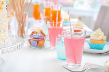 Glass with pink cocktail on table, closeup