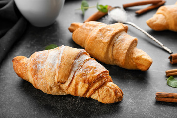 Tasty croissants on dark table