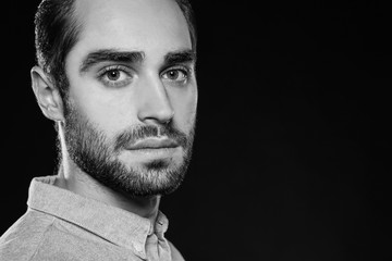 Young handsome man on black background