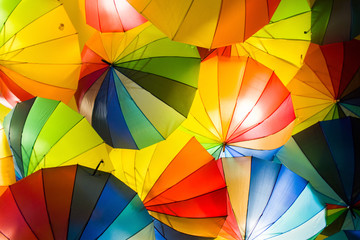 bright colorful hundreds of umbrellas floating above the street