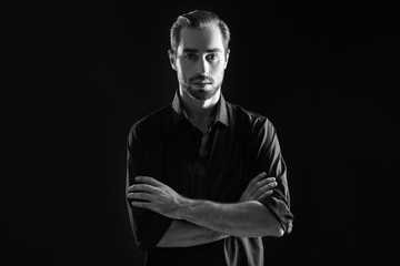 Young handsome man on black background