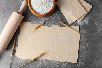 Raw flaky dough on table, top view