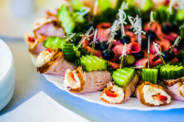 Sausage is filled with cheese filling with cucumber and olives