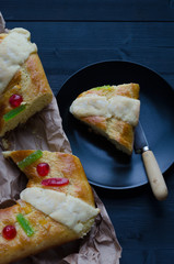 Portion of Kings thread on black plate on wooden background.