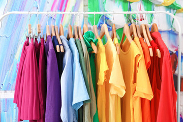 Rainbow clothes hanging on rack