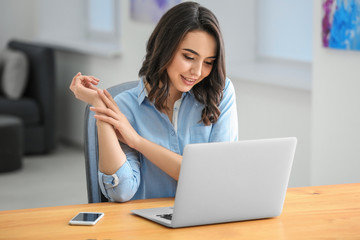 Young woman using laptop in office
