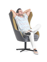 Handsome young man sitting in armchair on white background