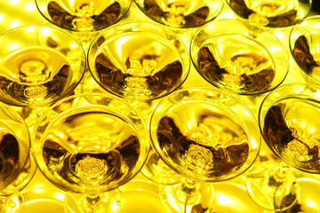 Glasses with sparkling wine lit from below the yellow light