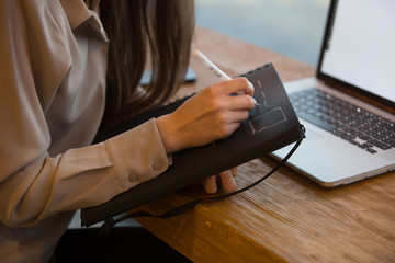 young beautiful business woman working using notebook and laptop