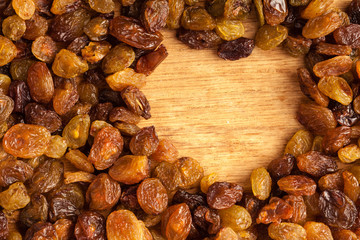 Diet healthy food. Border of raisin on wooden background