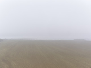 View over misty rural fields. Typical view in Czech Republic countryside.