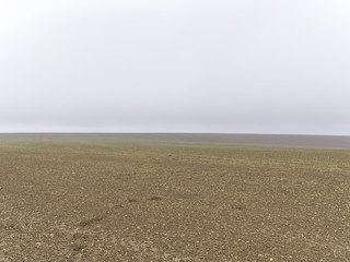 View over misty rural fields. Typical view in Czech Republic countryside.