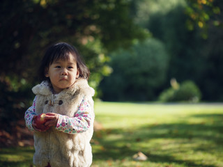 Baby girl playing at Autumn outdoor park