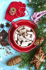 Homemade spicy warming hot chocolate with mini marshmallow in a red cup .Top view .