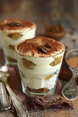 Homemade traditional italian dessert tiramisu with mascarpone cheese,savoyardi biscuit,coffee and whipped cream.