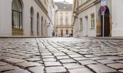 Fototapeta na wymiar Old street in the historical centre of Prague. Cobblestones close-up.