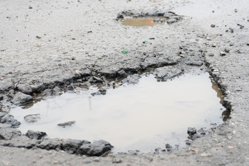 Potholes. Potholes dangerous to motorists and pedestrians.