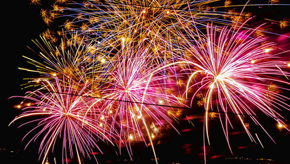 Fireworks. colorful pyrotechnic fires explode in the sky with a thousand sparkling lights and illuminate hot light the dark night of a party