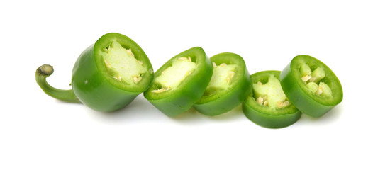fresh green cut chili pepper pieces on a white background 