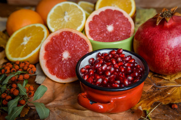 Mix of tropical fruits with lemon, orange, grapefruit, pomegranate on a vintage wooden board