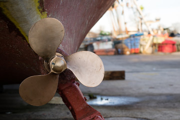The screw of a fishing boat exhibited in a port workshop. Repair of damaged fishing boats in the...