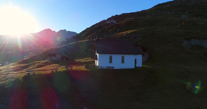 BEALP, WALLIS, SWITZERLAND, OCTOBER 15 Cinema 4k aerial decending view of a church on the summit of bealp mountain, on a sunny fall evening, in wallis, of the alps in Switzerland
