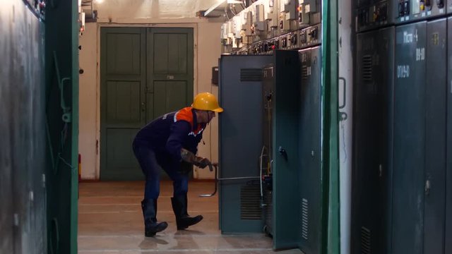 The engineer at the power station moves the current conductor