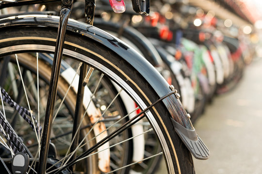 Bicycles parking on bicycle rack in downtown Amsterdam, The Netherlands