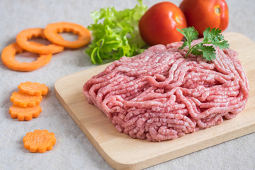 Raw minced pork on wooden chopping board