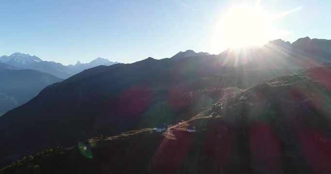 BEALP, WALLIS, SWITZERLAND, OCTOBER 15 Cinema 4k aerial view towards a church and a hotel on a summit village of bealp mountain, on a sunny fall evening, in wallis, of the alps in Switzerland