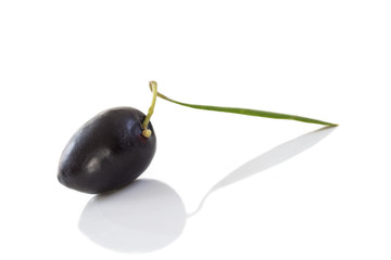 Close up black olive with his leaf and shadow on white backgeound