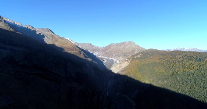 Glacier everfrost, Cinema 4k aerial rising view of altesch glacier from the summit of bealp mountain, on a sunny fall evening, in wallis, of the alps in Switzerland