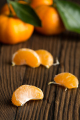 Peeled Mandarin slices on a wooden table